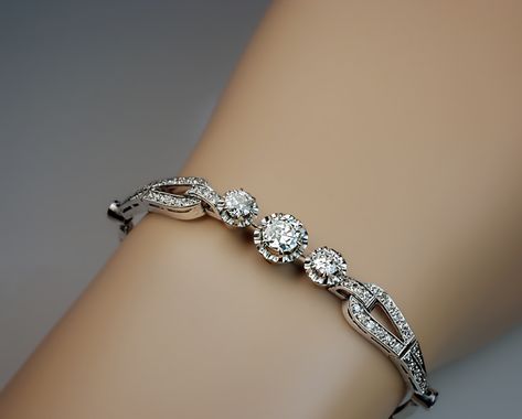 A Vintage Art Deco Diamond Platinum Bracelet circa 1920s. An elegant Art Deco diamond and platinum bracelet centered with three buttercup-set transitional Diamond Kada Bracelets, Bijoux Art Deco, Diamond Bracelet Design, Platinum Bracelet, Diamond Pendants Designs, Art Deco Bracelet, Indian Jewellery Design Earrings, Faberge Eggs, Jewelry Design Earrings