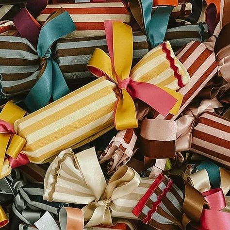 Colours of Arley on Instagram: "CRACKERS ARE BACK Our mixed boxes of striped recycled crackers have returned. Each cracker comes with a gift container inside so you can choose a small object for each member of the family. Restocked online and available for delivery or collect from the Hackney store this Saturday…Fabric is made in our workshops, crackers are made by @happy.crackers in Yorkshire." Colours Of Arley, Christmas Crackers Fillers Ideas, Fabric Decoration Ideas, Wedding Crackers, Holiday Product Photography, Boxes Decoration, Christmas Present Wrap, Small Gift Ideas, Storing Christmas Decorations