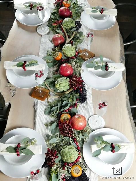 a beautiful natural Thanksgiving tablescape with a greenery runner, bold blooms, pomegranates, persimmons, artichokes and antlers Natural Thanksgiving Table, Greenery Runner, Fall Centerpieces, Rustic Thanksgiving, Thanksgiving Tablescape, Tablescape Ideas, Thanksgiving Table Settings, Thanksgiving Tablescapes, Fall Centerpiece