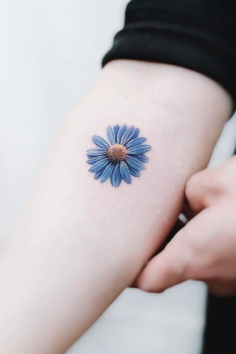 Exquisite blue daisy tattoo on arm Semicolon Tattoo Daisy, Small Tattoo Color, Blue Daisy Tattoo, Daisy Tattoo Designs Vintage, Daisy Wrist Tattoo, Daisy Tattoo Ideas, Daisy Tattoos, Iris Flower Tattoo, Daisy Tattoo Designs