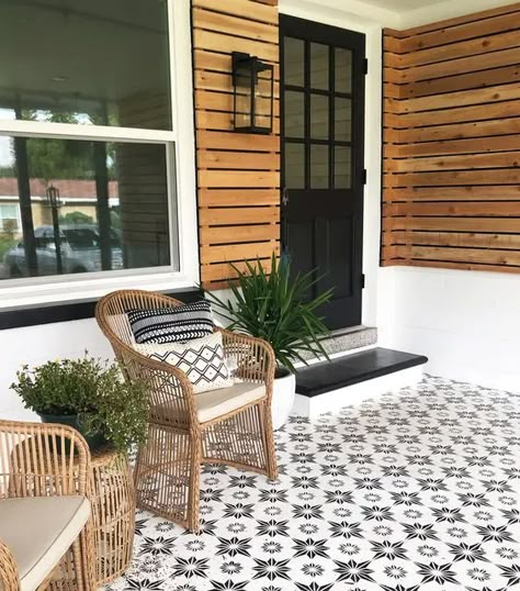 a modern porch clad with pretty star patterned tiles, with rattan chairs, potted greenery and a black door and steps is a chic idea Modern Front Porch Decor, Modern Front Porches, Front Porch Makeover, Modern Porch, Flip House, Porch Tile, Porch Remodel, Porch Makeover, Home Exterior Makeover