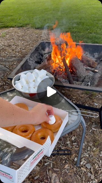 Hannah Gray | One Sweet Mama on Instagram: "Original glazed with a touch of 🔥 and a gooey marshmallow center #donuts #bonfire #marshmallows" Cooking Over A Campfire, Camp Desert Ideas, Campfire Donuts Recipe, S'more Combinations, Camping Donuts Recipe, Food To Roast Over Campfire, Dessert Over Campfire, Fire Pit Food Ideas On A Stick, Campfire Snacks For Kids