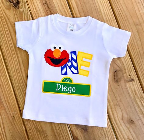 This listing is for (1) Kids Sesame Street Elmo Birthday Shirt. High quality shirts, thread and fabric are used. Please include the following at checkout: - Childs Name - Childs Age (One or Two) - Size Shirt White, Black and Gray shirts are available. If shirt color is not Elmo Birthday Shirts For Family, Sesame Street Birthday Shirt, Elmo Birthday Party Shirts, Elmo First Birthday Shirt, Sesame Street 1st Birthday Shirt, Sesame Street Birthday Party Ideas Boy, Elmo Birthday Party Boy, Sesame Street Birthday Cakes, Elmo First Birthday