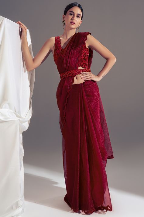 Featuring a deep red saree in organza base with a scalloped embroidery. It is paired with a matching suede embroidered blouse and a corset belt.  FIT: True to size. COMPOSITION: Suede, Organza. CARE: Dry clean only. Deep Red Saree, Scallop Saree, Red Organza Saree, Farewell Saree, Floral Sarees, Maroon Saree, Simple Saree Designs, Simple Sarees, Embroidered Saree