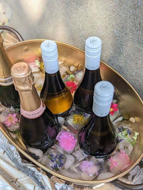 Champagne and white wine bucket with floral ice cubes Wine Display For Party, Ice Champagne Bucket, Ice Bucket Wedding, Ice Bucket For Party, Champagne Bucket Flowers, Wine Bucket Ideas, Wedding Ice Bucket, Folklore Party, Sabrina Movie