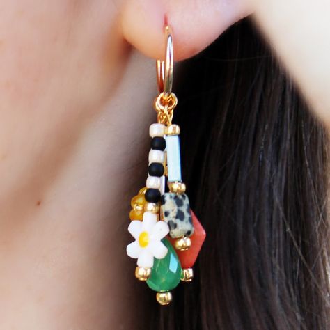 The Mariposa Beaded Earrings are fun personified! Five multicolored, beaded dangles are suspended from each gold huggie hoop and they are full of different colors, patterns, textures and shapes. We are beyond obsessed with this fun look! It is versatile for a variety of looks. Happy styling! Multicolored Natural stone, Czech glass, glass and gemstone beads Gold-filled hoops Nickel and lead free Hoop Diameter: 0.55 inch Do not drop or throw jewelry onto hard surfaces Avoid direct contact with spr Tiny Bead Earrings, Evil Eye Seed Bead Earrings, Charm Earrings Diy, Bohemian Earrings Diy, Diy Earrings Beads, Earring Shapes, Artsy Earrings, Diy Jewelry Making Tutorials, Bead Hoop Earrings