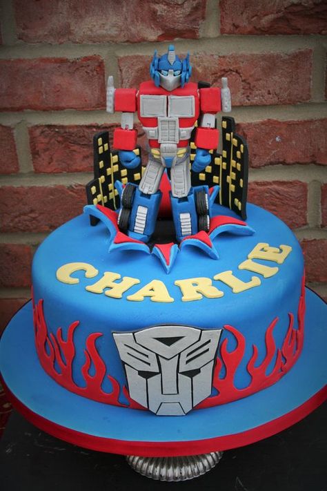 Optimus Prime birthday cake made by Sam Hallé Cakes Rescue Bots Birthday Cake, Transformers Birthday Cakes, Optimus Prime Birthday Cake, Transformer Cakes For Boys, Transformers Cake Ideas, Prime Birthday Cake, Transformers Cake Optimus Prime, Transformer Birthday Cake, Optimus Prime Birthday