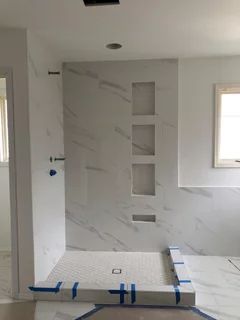 Shower Wall Ideas Solid Surface, Marble Shower Panels, Corian Bathroom Showers Solid Surface, Silestone Shower Walls, White Quartz Shower Walls, White Cultured Marble Shower Walls, Corian Shower Walls Walk In, Solid Panel Shower Walls, Bathroom Slabs Design