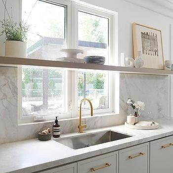 Shelf In Front Of Kitchen Window Design Ideas Open Shelves Kitchen Window, Shelves In Front Of Kitchen Window, Shelf Over Sink, Marble Slab Backsplash, Kitchen Window Shelf, Long Floating Shelf, 2025 Kitchen, White Farm Sink, Stainless Steel Apron Sink