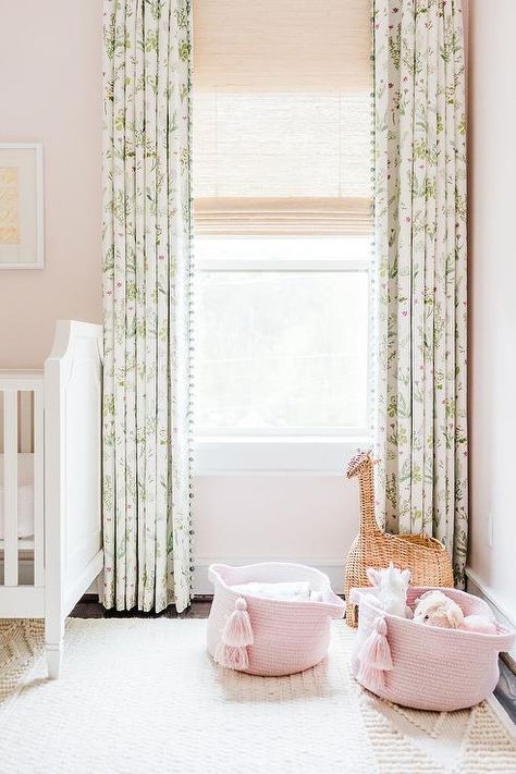 White and green floral pom pom curtains layered over cream Roman shades in a girls nursery adding a sophisticated touch against blush pink walls. Nursery Curtains Girl, Transitional Nursery, Pink And Green Nursery, Feminine Nursery, Nursery Inspiration Girl, Girl Nursery Room, Nursery Room Design, Pink Curtains, Nursery Curtains