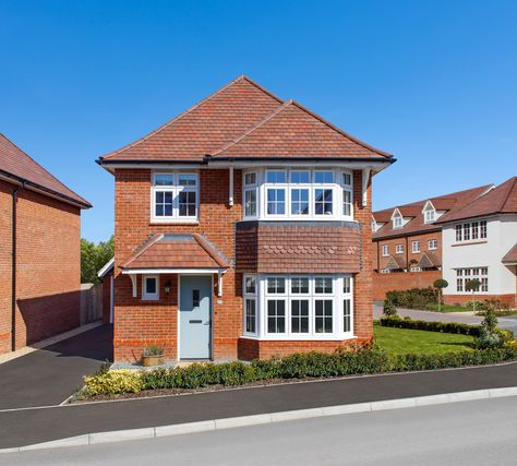 The front of a four-bedroom home. Red brick, three windows and a blue door. Homes With Character, Redrow Homes, Porch Supports, Traditional Porch, Timber Posts, Nice Homes, Doors And Floors, Hip Roof, Spacious Kitchens