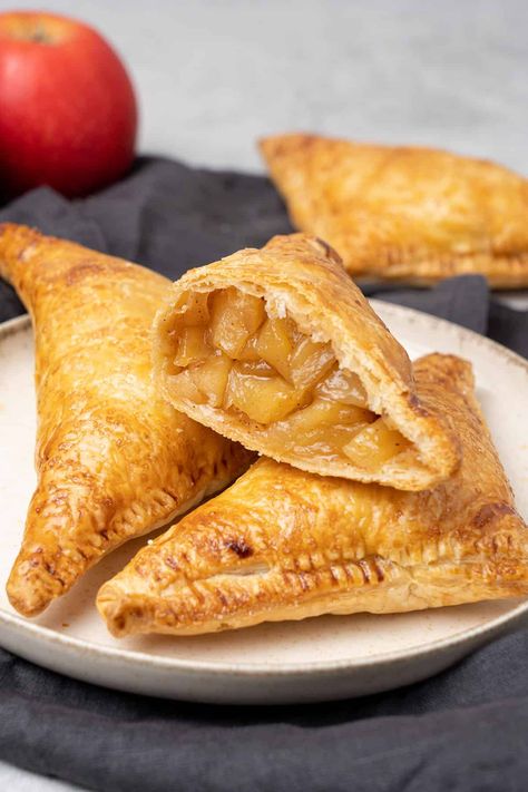 3 apple turnover on a a plate. Apple Recipes With Puff Pastry, Recipes With Puff Pastry, Sweet Puff Pastry Recipes, Perfect Flaky Pie Crust, Apple Turnover, Pastry Puff, Rough Puff Pastry, French Tart, Turnover Recipes