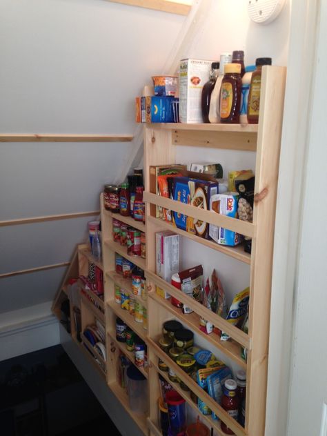 After picture - I was able to create a more useful storage system on the wall of the stairwell. I used pine boards from Lowes and some simple pocket hole joinery for the shelves and uprights as well as the stretcher boards between the sides that were screwed into studs. I also added shoe molding "rails" on each wall to hold 5 - 2' x 4' panels of 1/8" ply wood to cover the back of the stairs from the stairwell leading upstairs. Stair Wall Storage, Shelves In Stairwell, Stairwell Shelves, Shoe Storage On Stairs, Basement Steps Storage, Basement Stairwell Shelves, Stairway Pantry, Stairwell Storage, Stairwell Pantry