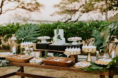 Tropical Dessert Table - Tropical Occasions Beachy Dessert Table, Hawaiian Dessert Table Ideas, Cake Dessert Table Wedding, Tropical Dessert Table Ideas, Tropical Wedding Buffet, Tropical Cake Table Decor, Tropical Dessert Table Wedding, Forest Green Dessert Table, Tropical Buffet Table Decor