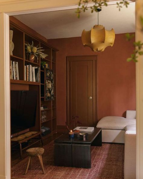 Orange Paint Living Room, Painted Window Frame Interior, Rust Colored Room, Dark Paint Interior, Dark Orange Walls, Rust Color Living Room, Rust Hallway, Cozy Room Colors, Red Carpet Interior