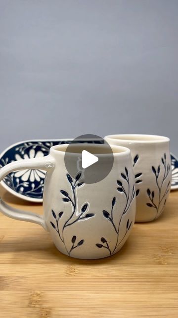 Linda on Instagram: "Here are the finished mugs from a few Reels ago. I was a little worried (and so were several commenters on that post 😅😂) that the blue underglaze would look smeary because I applied it after the cups had already been bisque fired. But I’m happy with how they turned out! This is Teal Blue velvet underglaze from @amacobrent  on @georgiesceramic White Salmon stoneware, design carved with @diamondcoretools fine point carving tools 🙌" Velvet Underglaze, White Pottery, Carving Tools, Shop Ideas, Blue Velvet, Teal Blue, New Shop, Stoneware, Carving