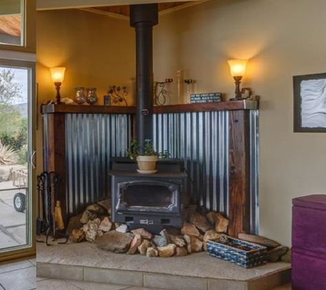 corregated metal with wood trim to protect wall behind the stove. Stunning and rustic. Rustic Bathroom Design, Corner Wood Stove, Wood Stove Surround, Wood Stove Hearth, Wood Stove Fireplace, Rustic Bathroom Designs, Bathroom Design Ideas, Into The Woods, Rustic Bathroom