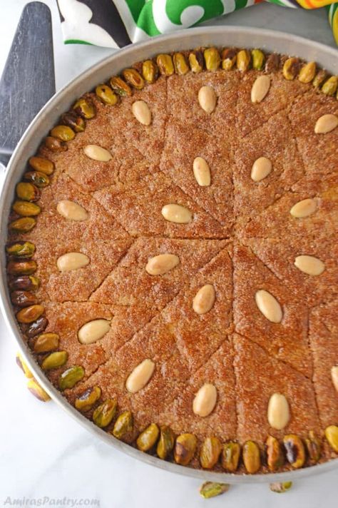 Basbousa is a delicious farina, yogurt and coconut cake. Decorated with nuts and drizzled with simple syrup. #basbousa Best Basbousa Recipe, Basboosa Recipe, Egyptian Dessert Recipes, Sudanese Food, Basbousa Recipe, Egyptian Desserts, Arabic Sweets Recipes, Lebanese Desserts, International Desserts