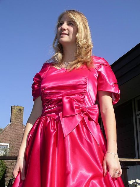 She is so girlish in her bright pink dress. The color goes well with her blond hair and the satin bow is so pretty and cute. Bright Pink Dress, Hot Pink Prom Dress, Ugly Dresses, Bright Pink Dresses, Disney Princess Dresses, Satin Saree, Taffeta Dress, Family Costumes, Hair Straight