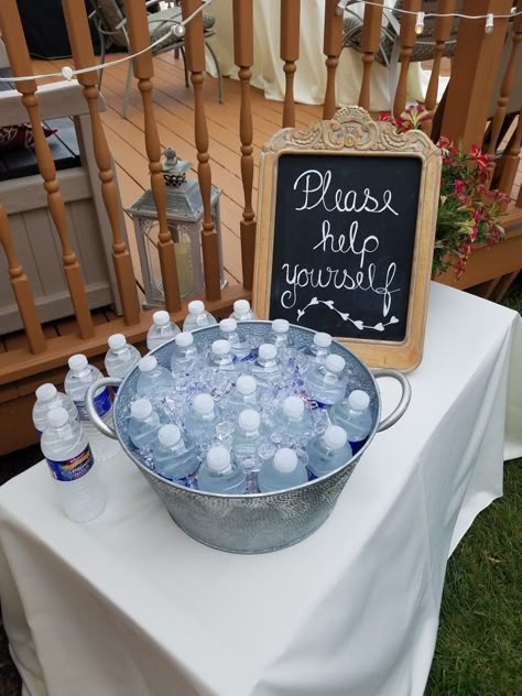 Water bottle display at an event Drinks For Party Display, Water Bottle Display For Party, Drink Display For Party Beverage Stations, Drink Table At Party, Beverage Display For Party, Water Bottle Display Wedding, Water Bottle Station, Drinks Dispenser Wedding, Outdoor Wedding Water Station