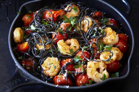 Black pasta, made from squid ink, is very dramatic and has a gutsier flavour than regular pasta. This black pasta dish looks lovely with various colours of cherry tomatoes but regular red or tinned tomatoes work equally well. Simply delicious!  #blacksquidpasta #20minutemeals #tinnedtomatoes #seafoodpasta Black Ink Pasta Recipes, Black Pasta Dishes, Black Pasta Recipe, Squid Ink Pasta Recipe, Black Pasta, Squid Ink Pasta, Crab Pasta, Veggie Fries, Scampi Recipe