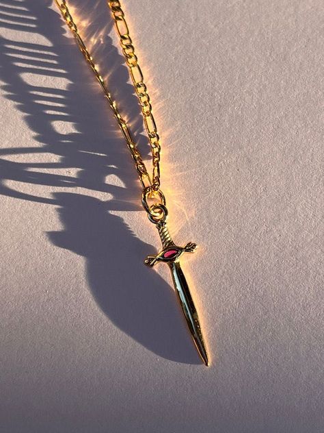 Gold Dagger Necklace, Multiple Pendant Necklace, Symbolic Necklaces, Dagger Jewelry, Pendant Necklace Outfit, Gold Ruby Necklace, Peter Pevensie, Dagger Necklace, White Blouses