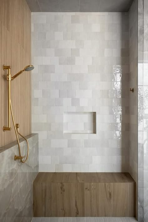 A brown teak shower bench is fixed against gray brickwork square tiles under a gray tiled niche. Bathroom With Sitting Bench, Shower Ledge And Bench, Niche Above Shower Bench, Square Tile Bathroom Walls, Square Subway Tile Bathroom, Offset Square Tile, Shower Bench Ideas Built Ins, Master Shower With Bench, Tiled Shower Bench