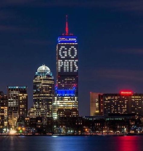 Boston Prudential Center lit for the New England Patriots | Charles River at night | PATS #GOPATS River At Night, Tom Brady Patriots, Prudential Center, England Sports, Go Pats, New England Patriots Football, Detroit Red Wings Hockey, Pittsburgh Penguins Hockey, Patriots Fans