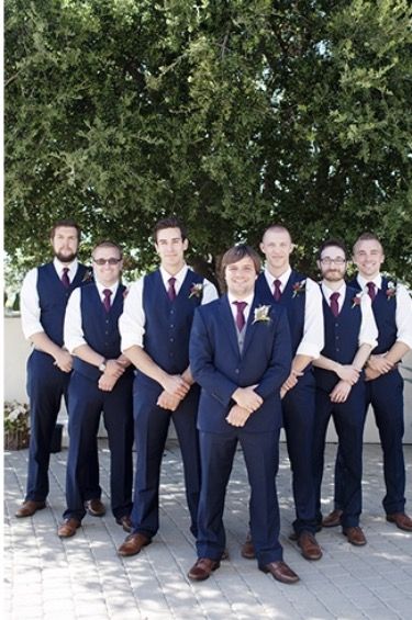 Groomsmen party- Groom in Navy Blue suit with a white shirt and purple tie. Groomsmen in navy blue pants and vest with white shirt and purple tie. All with brown belts and brown shoes. Groom And Groomsmen Attire Purple, Groomsmen Vest Attire, Groomsmen Attire Navy Burgundy, Navy Blue Groomsmen Attire, Navy Blue Vest Groomsmen, Navy Suit Purple Tie, Blue And Purple Groomsmen Attire, Navy Vest Groomsmen, Groomsmen Attire Purple