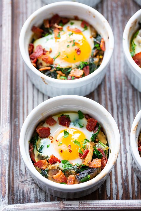 Made in single serving ramekins, these baked eggs are packed with savory goodies and flavor!   Great for weekend brunches and make-ahead friendly for weekdays.  Paleo, Whole30 compliant and keto friendly. Superhero Breakfast, Nutrition Reset, Baked Eggs With Spinach, Ramekin Recipe, Eggs With Spinach, Paleo Breakfasts, Paleo Running Momma, Whole30 Keto, Bacon Stuffed Mushrooms