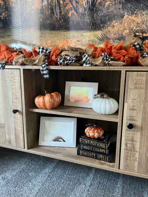 Fall Halloween Tv Stand Decor, Entertainment Fall Decor, Hobby Lobby Tv Stand Decor, Fall Decorations Tv Stand, Fall Tv Decor Tv Stands, Fall Decor Around Tv Stand, Fall Decorated Entertainment Center, Autumn Tv Stand Decor, Fall Decor Console Table Under Tv