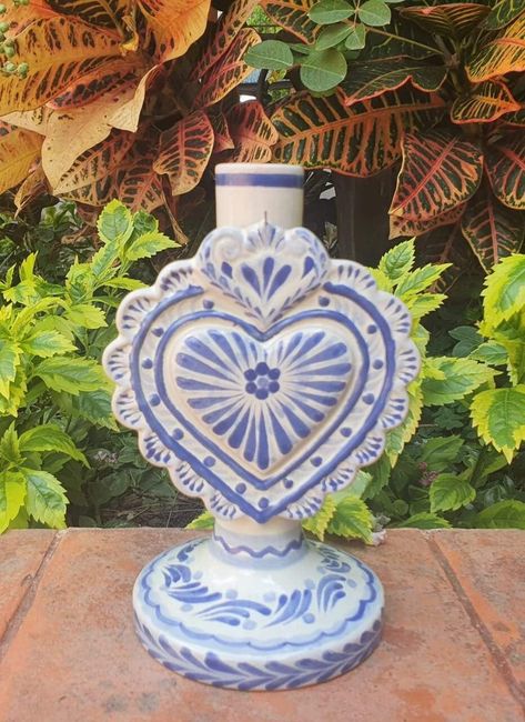 LOVE HEAR CANDLE HOLDER 4.3in W  X 5.1in L  X 7.7in H 11cm A  X 13cm L  X 19.5cm Alt Internationally recognized and Award Winner Gorky Gonzalez and his workshop have dedicated their work to rescue the traditional majolica of Guanajuato, Mexico.   Each piece is carefully handcrafted. Lead Free handcrafts handmade Mexico visit our website to see more pieces https://gorkygonzalez.com/collections/mexican-pottery-saints-collection Mexican Pottery Decor, Garden Gate Ideas, Blue Talavera, Talavera Art, Hacienda Decor, Talavera Design, Heart Candle Holder, Mexican Kitchen Decor, Hacienda Wedding