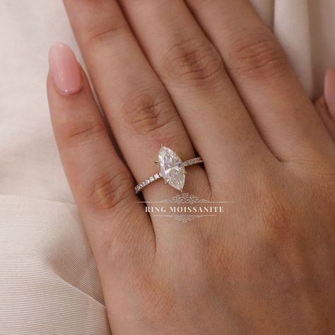 Unique 2.6 carat marquise moissanite engagement ring.

- Style : solitaire / pave band / hidden halo
- 2.6 carat center
- 12*6mm marquise cut, colorless moissanite in 14k yellow gold

For more details comment below. Marquise Solitaire Engagement Ring With Band, Marquise Engagement Ring With Pave Band, Marquise Engagement Ring Pave Band, Marquise Pave Engagement Ring, Pave Marquise Engagement Ring, Marquise Engagement Ring Gold, Marquise Moissanite Engagement Ring, Gold Band Engagement Rings, Pave Band Engagement Ring