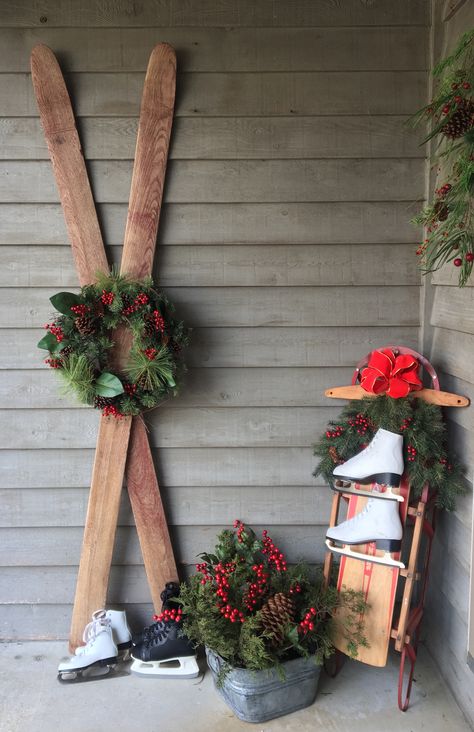 Christmas porch decor includes old skis, sled, skates and winter greenery with red bow, galvanized tub with fresh cut cedar and pine cones Vintage Remodel, Easy Outdoor Christmas Decorations, Christmas Sled Decoration, Outdoor Christmas Diy, Christmas Sled, Ski Decor, Christmas Front Porch, Christmas Porch Decor, Christmas Decorations Diy Outdoor