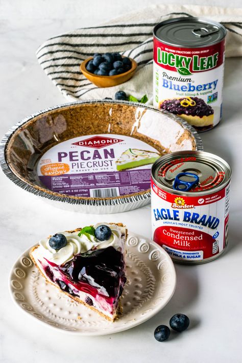 No-Bake Blueberry Cheesecake made with Eagle Brand® Sweetened Condensed Milk, Lucky Leaf® Premium Blueberry Fruit Filling, and Diamond of California® Pecan Pie Crust #ad #nobake #easy #easter #desserts #pie #blueberry #cheesecake #nobakecheesecake #condensedmilk #spring #tart No Bake Cheesecake With Eagle Brand Milk, Pecan Crust Pie Dessert Recipes, Eagle Brand Cheesecake Recipes, Eagle Brand Cheesecake, Spring Tart, Desserts Pie, Pie Blueberry, Blueberry Cheesecake Recipe, No Bake Blueberry Cheesecake