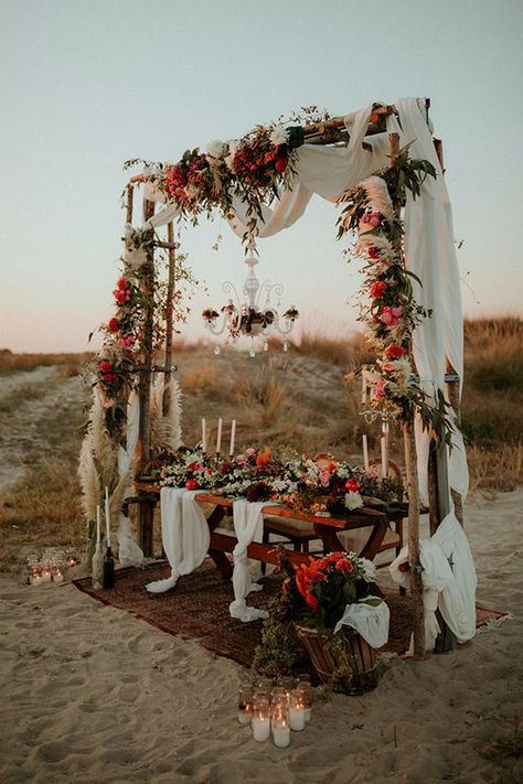 a colorful boho beach wedding reception space with colorful blooms and pampas grass, a crystal chandeliet, airy runners and lots of candles Boho Wedding Arch, Moderne Have, Rustic Wedding Decorations, Wedding Ceremony Ideas, Succulent Wedding, Wedding Flower Decorations, Wedding Boho, Brasov, Desert Wedding