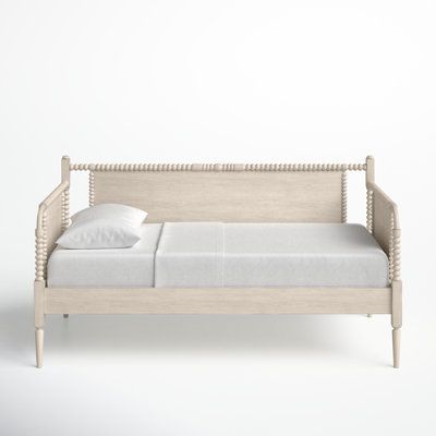 This twin daybed is exactly what you need in your guest room, especially if last-minute guests always seem to end up at your house. Carefully built from solid and manufactured wood in an antique white painted finish, this 80"-wide daybed has smooth panels accented by traditional turned legs and knobs for a decorative touch, while a slat system accommodates your preferred mattress. Why don't you put it in your spare room and top it with a few patterned throw pillows? Something to remember for lat Farmhouse Daybeds, Daybed Twin, Carriage House Apartments, Trundle Bed With Storage, Twin Daybed, Wood Daybed, Natural Living Room, Condo Design, Twin Mattress Size