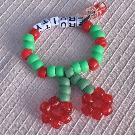 kandi cherry pattern bracelet single with mini strawberry drink charm 🧃 Bead Colors: red, green Measurements: 17 - 21 cm  The length measurement is of the circumference of the bracelet. The first number is the inner circumference, the second is the outer circumference. All bracelets are stretchy and size my vary slightly due to the elastic stretch. Single Kandi Bracelets Ideas, Single Kandi Bracelets, Kandi Pants Chain, Kandi Charms Ideas, Simple Kandi Ideas, Kandi Ideas Bracelets, Red Bracelet Ideas, Kandi Mushroom, Kandi Bracelets Patterns