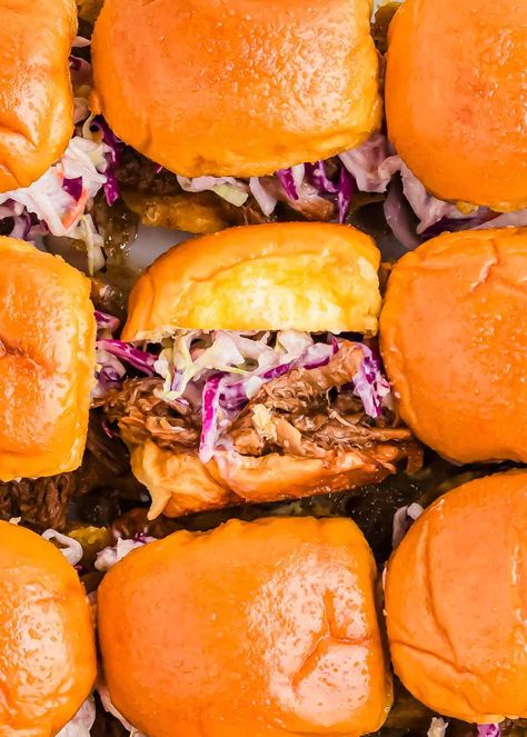 Make the ultimate BBQ pulled pork sliders with this easy pulled pork slider recipe! Tender pulled pork, topped with tangy coleslaw, all served on soft Hawaiian rolls, makes these sliders perfect for game days or parties. Whether you're using the slow cooker or Instant Pot, these pulled pork sliders come together effortlessly and will be a hit with any crowd. Slow Cooker Pulled Pork Sliders, Slaw For Pork Sliders, Bbq Hawaiian Roll Sliders, Pulled Pork Sliders For A Crowd, Pulled Pork Hawaiian Rolls Sliders, Pulled Pork Slow Cooker Easy, Bbq Sliders Recipes Hawaiian Rolls, Pulled Pork Sliders Hawaiian Rolls, Pork Sliders Hawaiian Rolls