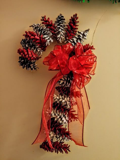 The wreath form and ribbon were from Dollar Tree and the paint was from Walmart. The pine cones are from my yard! Complete for under 5 dollars!! Red Pine Cones, Candy Cane Pine Cone Wreath, Christmas Wreaths With Pine Cones, Pine Cone Candy Cane Wreath, Pine Cone Candy Cane, Pinecone Candy Cane, Pinecone Candy Cane Wreath, Ideas For Pine Cones, Pinecone Wreath Christmas