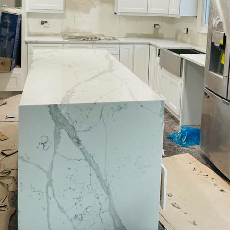 And the island emerdged in all its glory! 💫 😍 ⚡ Learn more about your options with waterfall islands on our website or give us a shout for more info. #quartz #quartzcountertops #decorcrushing #kitchengoals #whitekitchendesign #calacattazoya #calacattaquartz #quartzisland #kitchencrush #quartzbacksplash #currentdesignsituation #kitchencabinets #waterfallkitchenisland #kitchenupdates #openconceptliving #openconcept #kitcheninspo #makehomeyours #whitekitchen #kitchendesign #kitchendesigner One Side Waterfall Island Kitchen, Waterfall Kitchen Island Ideas, Waterfall Countertop Island, White Marble Waterfall Island, Waterfall Island Kitchen Outlet, Quartz Island Waterfall, Kitchen Island Quartz Counter Tops Waterfall, Kitchen Island Quartz, Waterfall Island Kitchen