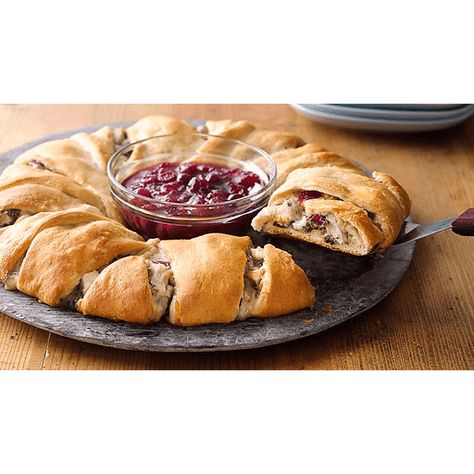 Bring new life to leftovers with this easy Thanksgiving crescent ring meal! Turkey, cranberry sauce, cheese and spinach get wrapped up in flaky crescent dough for a delicious dinner that's just as fun to eat as it is convenient to pull together. Serve up this Thanksgiving crescent roll ring with a bowl of cranberry sauce in the middle for an extra pretty presentation. Turkey Crescent Ring, Thanksgiving Crescent Rolls, Crescent Roll Ring, Turkey And Cranberry, Cranberry Turkey, Turkey Cranberry, Cheese Crescent Rolls, Crescent Ring, Turkey Cheese