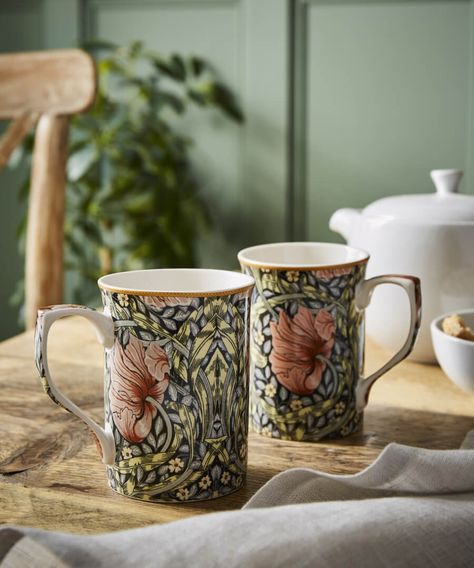 With a pimpernel mug set, you can bring some elegance to your morning coffee. See how detailed, ornate and bold the stunning pimpernel print looks? With two mugs included in the set, and plenty of matching kitchenware available, they're sure to help brighten your space.  Set includes 2 beautiful mugs Statement William Morris pimpernel print Matching accessories available Approx Dimentions: 11.5 x 7.6 x 10.5cm  This item has been created to the highest UK Safety Standards, but unfortunately it is William Morris Mugs, William Morris Pimpernel, Unique Wine Glasses, Beautiful Mugs, New Victorian, Winter Floral, Floral Tablecloth, English House, Joe Browns