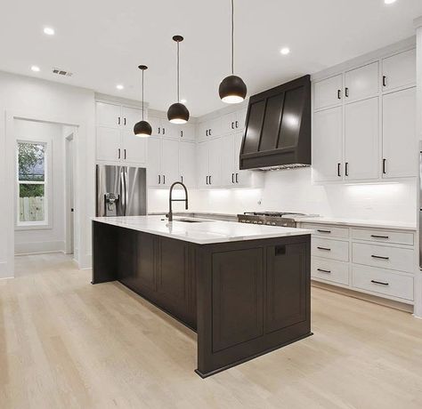 Black And White Kitchen Accent Color, White Kitchens With Dark Islands, White Cabinet Black Island, Iron Ore Kitchen Island White Cabinets, Black Island Dark Floors, White Cabinets With Black Island, White Cabinets With Black Island And Wooden Hood Vent, Black Island And Hood, Black Lantern Kitchen Island