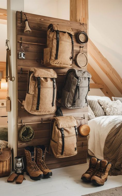 A rustic bedroom featuring a wooden backpacking gear wall with natural-toned backpacks and gear. Hiking Room Ideas, Gear Wall, Storage Bedroom, Storage Idea, Backpacking Gear, Backpack Storage, Bedroom Storage, Earthy Tones, Bedroom Makeover