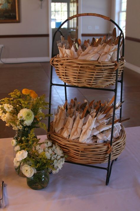 another inexpensive way to wrap utensils in napkins in this two tiered basket on buffet table Cutlery Decoration Party Ideas, Wedding Shower Buffet Table Ideas, Good Buffet Display, Table Settings For Mens Birthday, How To Set Buffet Table, Utensil Holder For Wedding Reception, Wedding Utensil Holder, Cutlery Party Display, Utensil Party Display