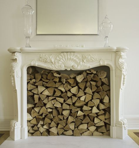 Why You Should Never Store Firewood Indoors—No Matter How Cute It Lookscountryliving Keeping Room Off Kitchen With Fireplace, Keeping Room Off Kitchen, Stacked Firewood, Store Firewood, Firewood Storage Indoor, Kitchen With Fireplace, Firewood Storage Outdoor, Room Off Kitchen, Firewood Storage