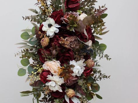 Elevate your wedding decor with our stunning artificial floral arch arrangements! 🌿 This romantic setup, featuring deep burgundy, ivory, and lush greenery, brings timeless elegance to any ceremony. Complement your look with our matching cascading bouquets, centerpieces, and hair accessories — all designed to create a cohesive and beautiful atmosphere on your big day. 💐 Perfect for boho, rustic, and modern weddings alike! 💍 #burgundyarch #archdecor #archflowers #Arches #flowersdecoration #Fl... Floral Arch Arrangements, Arch Flowers, Cascade Bouquet, Ceremony Arch, Floral Arch, Deep Burgundy, Lush Greenery, Wedding Modern, All Design