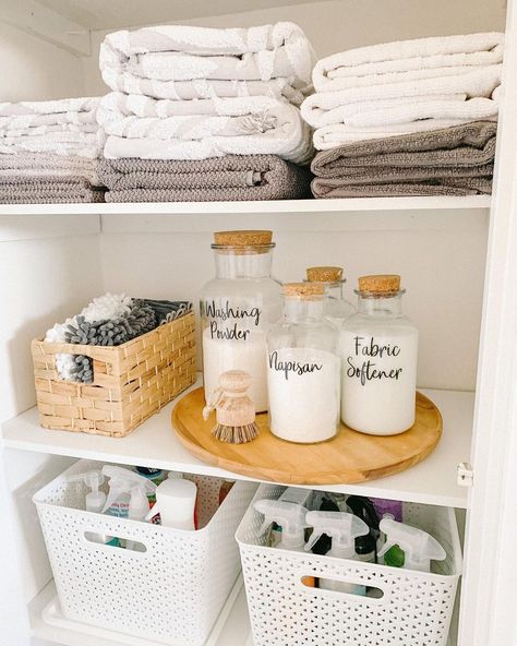 If you're lucky enough to have a separate closet for storing laundry supplies, this curated cabinet is for you. On the top shelf are folded towels, above a shelf dedicated to laundry detergent in small glass cork jars. Cleaning cabinets are a great way to keep supplies that shouldn't be displayed tucked away, and the shelf for towels is a bonus. Bathroom Organization Baskets, Detergent Storage Ideas, Diy Laundry Room Storage, Storing Towels, Laundry Room Flooring, Laundry Design, House Organisation, Laundry Room Inspiration, Laundry Decor