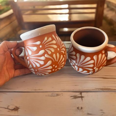 PRICES MAY VARY. Handmade Clay Mugs Beautiful white design on a terracotta background Enjoy your favorite beverages with this charming set of 2 Talavera mugs, each holding 12 ounces. Handcrafted by skilled Mexican artisans, these mugs feature a beautiful white design with a terracotta base. Perfect for coffee, tea, or any drink of your choice, these mugs bring a touch of vibrant artistry to your daily routine. Whether for personal use or as a unique gift, these mugs are a delightful addition to Hacienda Moderna, Terracotta Mugs, Mexican Pottery Decor, Terracotta Design, Dream Inspiration, Painted Pots Diy, Hand Painted Candles, Mexican Ceramics, Talavera Pottery